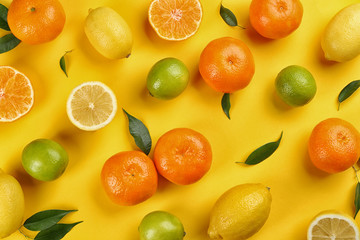 Flat lay composition with tangerines and different citrus fruits on yellow background