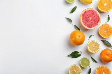 Flat lay composition with tangerines and different citrus fruits on white background. Space for text
