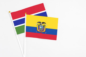 Ecuador and Georgia stick flags on white background. High quality fabric, miniature national flag. Peaceful global concept.White floor for copy space.