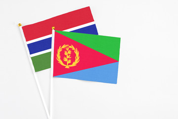 Eritrea and Georgia stick flags on white background. High quality fabric, miniature national flag. Peaceful global concept.White floor for copy space.