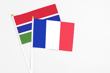 France and Georgia stick flags on white background. High quality fabric, miniature national flag. Peaceful global concept.White floor for copy space.