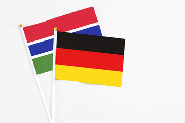 Germany and Georgia stick flags on white background. High quality fabric, miniature national flag. Peaceful global concept.White floor for copy space.