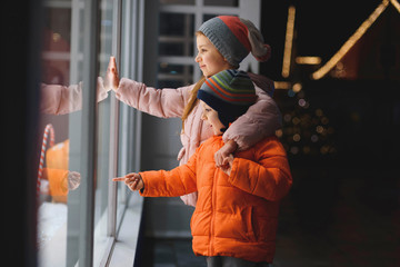 smiling children looking at christmas gifts
