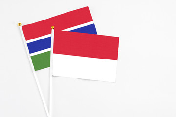 Indonesia and Georgia stick flags on white background. High quality fabric, miniature national flag. Peaceful global concept.White floor for copy space.