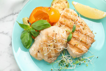 Tasty grilled fish on marble table, closeup