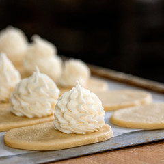 Finished production raw sochniki sochni with cottage cheese in factory in the steel table. Traditional Russian shortbread with cottage cheese. Working process. Private bakery.