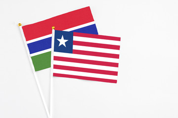 Liberia and Georgia stick flags on white background. High quality fabric, miniature national flag. Peaceful global concept.White floor for copy space.