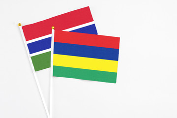 Mauritius and Georgia stick flags on white background. High quality fabric, miniature national flag. Peaceful global concept.White floor for copy space.