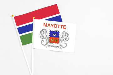 Mayotte and Georgia stick flags on white background. High quality fabric, miniature national flag. Peaceful global concept.White floor for copy space.