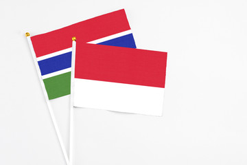 Monaco and Georgia stick flags on white background. High quality fabric, miniature national flag. Peaceful global concept.White floor for copy space.