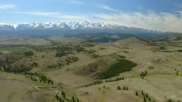 Aerial Drone View: flight over a beautiful mountainous area with mountains in the snow. 4K motion