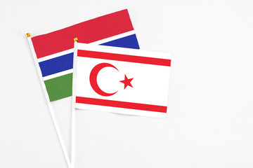 Northern Cyprus and Georgia stick flags on white background. High quality fabric, miniature national flag. Peaceful global concept.White floor for copy space.