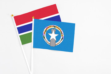 Northern Mariana Islands and Georgia stick flags on white background. High quality fabric, miniature national flag. Peaceful global concept.White floor for copy space.