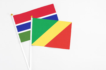 Republic Of The Congo and Georgia stick flags on white background. High quality fabric, miniature national flag. Peaceful global concept.White floor for copy space.