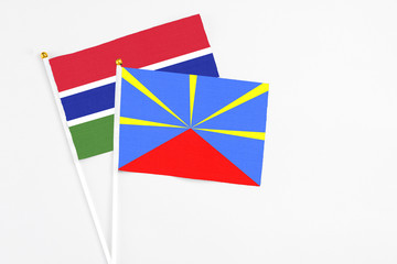 Reunion and Georgia stick flags on white background. High quality fabric, miniature national flag. Peaceful global concept.White floor for copy space.