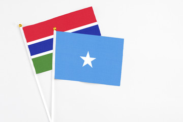 Somalia and Georgia stick flags on white background. High quality fabric, miniature national flag. Peaceful global concept.White floor for copy space.
