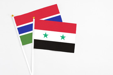 Syria and Georgia stick flags on white background. High quality fabric, miniature national flag. Peaceful global concept.White floor for copy space.