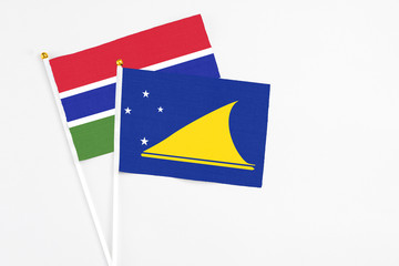 Tokelau and Georgia stick flags on white background. High quality fabric, miniature national flag. Peaceful global concept.White floor for copy space.