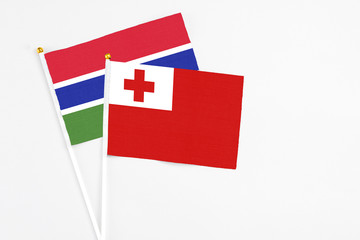 Tonga and Georgia stick flags on white background. High quality fabric, miniature national flag. Peaceful global concept.White floor for copy space.