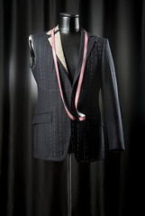 suit jacket with tailor mannequin on a black background