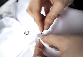 close-up of a tailor sewing shirt