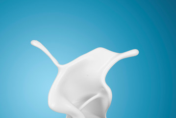 milk or white liquid splash on blue background.