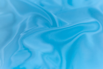 Soft focus of blue color silk fabricl background texture.