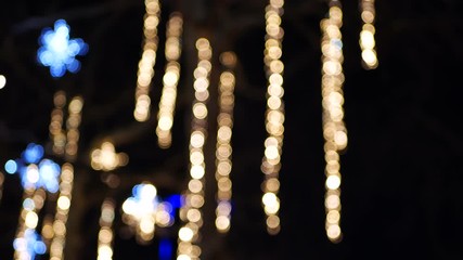 Blurred flashing christmas lights in London. Blue stars and icicles  4K