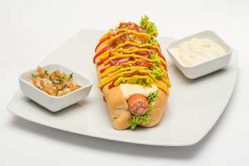 Hot dog on plate with sauces