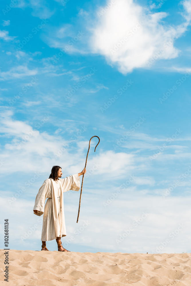 Canvas Prints handsome man in jesus robe holding wooden cane