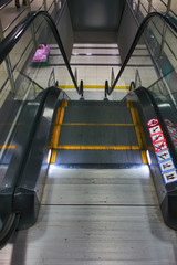 Staircase of an automatic escalator in a shopping center close-up.