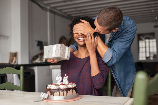 Man surprising girl on birthday - Powered by Adobe