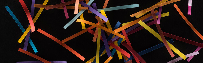 top view of multicolored abstract lines scattered isolated on black background, connection and communication concept