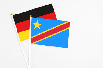 Congo and Germany stick flags on white background. High quality fabric, miniature national flag. Peaceful global concept.White floor for copy space.