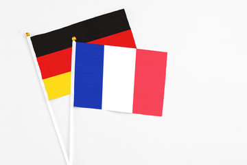 France and Germany stick flags on white background. High quality fabric, miniature national flag. Peaceful global concept.White floor for copy space.