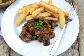 bourguignon beef and fries on a plate