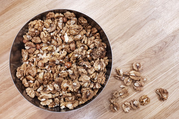 walnuts in a plate on a wooden table