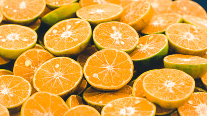 Sliced orange background . Colorful orange citrus fruit slices . Half orange fruit , fresh and juicy . healthy food and vitamin C