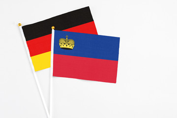 Liechtenstein and Germany stick flags on white background. High quality fabric, miniature national flag. Peaceful global concept.White floor for copy space.