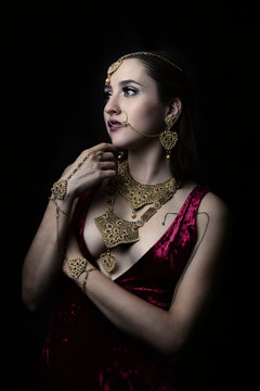 Beautiful portrait of youg model wearing Indian jewelry posing in studio black background Isolated, Mexico.