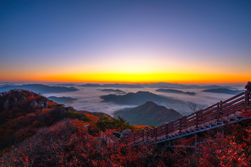 The horizon line is normally covered with morning mist in autumn on the peak of Chunmasan Mountain in Seoul, South Korea.