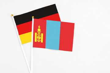 Mongolia and Germany stick flags on white background. High quality fabric, miniature national flag. Peaceful global concept.White floor for copy space.