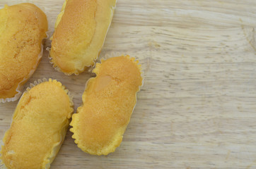 Delicious creamy bread on a wooden background