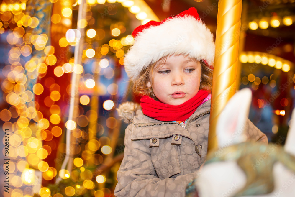 Canvas Prints pretty young girl taking a ride in a carousel at christmas