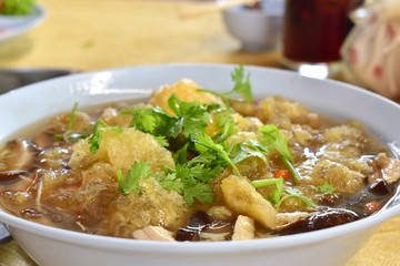 Bowl of fish maw soup on table food