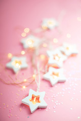Merry Christmas and Happy Holidays  banner and greeting card. New Year. Wooden stars on a yellow christmas light bokeh background with copy space.Winter holiday theme.Wallpaper.