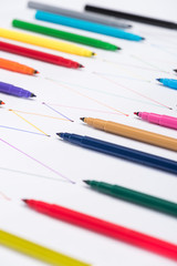 selective focus of multicolored felt-tip pens on white background with connected drawn lines, connection and communication concept