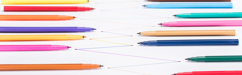 selective focus of colorful felt-tip pens on white background with connected drawn lines,...