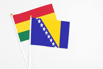 Bosnia Herzegovina and Ghana stick flags on white background. High quality fabric, miniature...