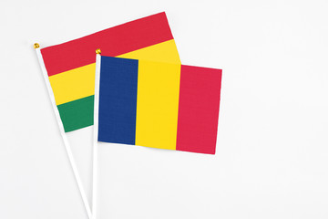 Chad and Ghana stick flags on white background. High quality fabric, miniature national flag....